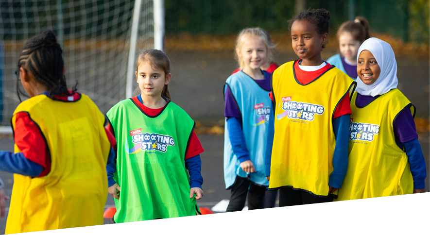 Group of girls taking part in  Shooting Stars girls' football programme
